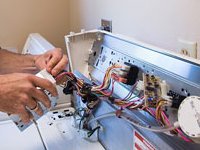 Un nostro tecnico impegnato nella riparazione di una lavatrice Un nostro tecnico impegnato nella riparazione di una lavatrice